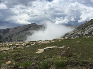 The first cloud whips up from the valley.
