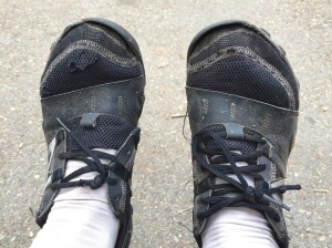 Close-up of Babz's feet-saving shoes: New Balance Minimus trail runners. they're a discarded pair of mine that she brought to use as water shoes and around-camp wear. Now they are REALLY worn out!